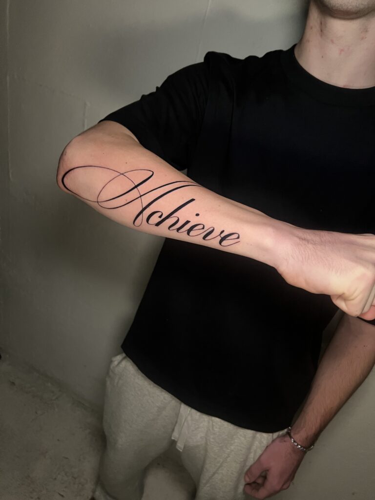 Clean black script tattoo with smooth lettering and balanced spacing