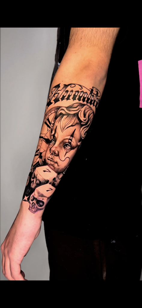 Realistic black and grey baby face tattoo with soft shading